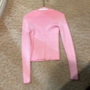 Woman’s pink ribbed sweater